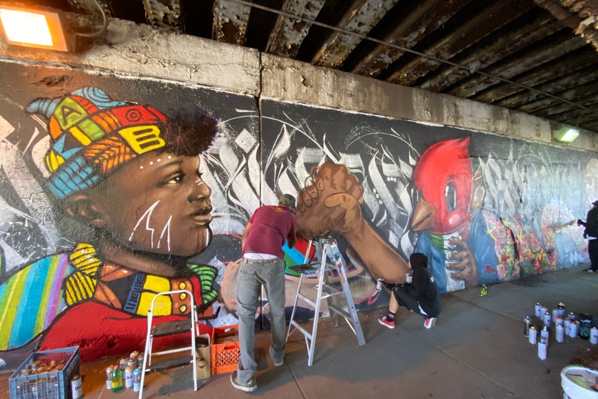 Artists painting the Unity Mural